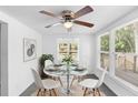 Bright dining room with modern lighting, glass table, and white chairs at 211 S Delaware Ave, Deland, FL 32720