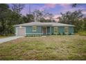 Charming single-story home featuring a new lawn and a front-facing two-car garage at 2145 8Th Ave, Deland, FL 32724