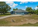 Expansive property featuring a well-kept lawn and driveway leading to an attached two-car garage at 2150 Deck Ct, Deltona, FL 32738