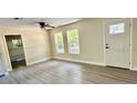 Bright, open living room with sleek floors and natural light from the large windows at 249 Citra St, De Leon Springs, FL 32130