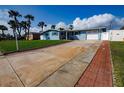 Beautiful single-story home with brick-lined driveway and lush lawn at 2573 W Coral Way, Daytona Beach, FL 32118