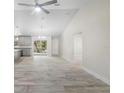 Spacious open-concept with kitchen and living room featuring modern lighting, and gorgeous tile floors at 266 Buford Ave, Orange City, FL 32763