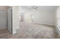 Spacious living room featuring vaulted ceiling, ceiling fan and neutral paint with beautiful tile floor at 266 Buford Ave, Orange City, FL 32763