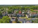 Community aerial view highlighting landscaping, parking, and a glimpse of a nearby lake at 2704 Lancaster Ct, Apopka, FL 32703
