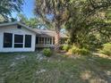 Inviting single-story home with screened porch, perfect for enjoying the outdoors at 328 W Connecticut Ave, Lake Helen, FL 32744