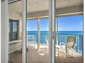 Spacious balcony with comfortable seating offering stunning views of the ocean and bright blue skies at 3425 S Atlantic Ave # 1206, Daytona Beach Shores, FL 32118