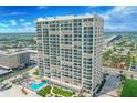 Stunning high-rise condo building with a pool and beautiful landscaping, offering panoramic views of the ocean and city at 3425 S Atlantic Ave # 1206, Daytona Beach Shores, FL 32118