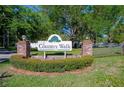 Community sign for 'Country Walk', with brick columns, landscaping, and trees in the background at 3441 Country Walk Dr, Port Orange, FL 32129