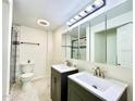 Modern bathroom with double vanities, stylish lighting, and a tiled shower at 370 S Center St, Ormond Beach, FL 32174
