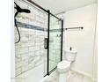 Contemporary bathroom featuring a walk-in shower with sleek glass door and tiled walls at 370 S Center St, Ormond Beach, FL 32174