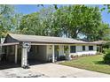 Charming single-story home with a covered carport, inviting curb appeal, and well-kept landscaping at 421 Hope Ter, Maitland, FL 32751