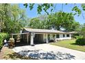 Inviting single-story home with covered parking, a basketball hoop and well-maintained landscaping at 421 Hope Ter, Maitland, FL 32751