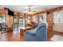 Bright living room features wood walls, comfortable seating and views of a screened porch at 4293 Cypress Bnd, Geneva, FL 32732