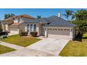 Inviting home showcases arched windows, manicured landscaping, a concrete driveway, and a two-car garage at 4534 Bond Ln, Oviedo, FL 32765