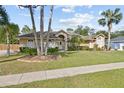 Beautiful single-story home with lush lawn and mature trees providing a serene setting at 481 W Holly Dr, Orange City, FL 32763