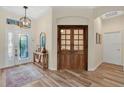 Spacious foyer with wood floors, stylish decor, and a decorative front door that leads into the home at 483 N Pine Meadow Dr, Debary, FL 32713