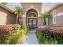Inviting front entrance featuring a walkway surrounded by manicured landscaping and a welcoming doorway at 484 Lanarkshire Pl, Apopka, FL 32712