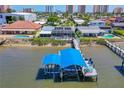 View of covered boat lift and deck overlooking the water, perfect for enjoying waterfront living at 5 Talo Cir, Port Orange, FL 32127