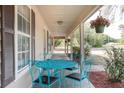 Relaxing front porch with a cozy seating area and hanging plants at 5410 Deleon Springs Ranch Rd, De Leon Springs, FL 32130