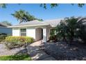 Inviting single-story home with well-maintained landscaping and a covered entryway, enhancing curb appeal at 5479 Saint Regis Way, Port Orange, FL 32128
