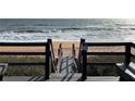 A boardwalk with stairs leads to a beautiful sandy beach and ocean, promoting easy access for residents at 5500 Ocean Shore Blvd # Ut18, Ormond Beach, FL 32176