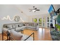 Bright and airy living room featuring comfortable seating, hardwood floors, and access to the outdoors at 563 Belltower Ave # 240, Deltona, FL 32725