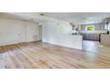 Open-concept living room with hardwood floors connecting to the kitchen at 607 Herbert St, Port Orange, FL 32129
