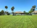 Large grassy backyard, perfect for outdoor activities, with a screened porch at 6182 Knotty Pine Ct, Port Orange, FL 32127