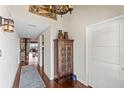 Inviting foyer featuring hardwood floors, a decorative cabinet, and elegant lighting fixtures at 761 Marina Point Dr # 7610, Daytona Beach, FL 32114