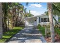 Inviting home with a long driveway and green landscaping at 82 Margaret Rd, Ormond Beach, FL 32176