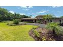 Beautifully landscaped property features a winding driveway, lush lawn, and well-maintained greenery at 910 N Kepler Rd, Deland, FL 32724