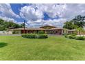 Spacious single-story home featuring a lush front lawn and meticulously maintained landscaping at 910 N Kepler Rd, Deland, FL 32724