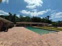 Inviting in-ground pool featuring a brick patio perfect for outdoor relaxation and entertainment at 910 N Kepler Rd, Deland, FL 32724