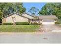 Charming single-story home with a well-manicured lawn and a two-car garage at 101 Sweetwater Oaks Ln, Daytona Beach, FL 32114