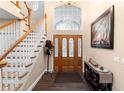 Welcoming foyer with hardwood floors, staircase, and a decorative front door at 1081 Torchwood Dr, Deland, FL 32724