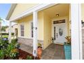 Inviting front porch with decorative plants, stone accents, and a white front door at 112 Coral Reef Ct, Sanford, FL 32771