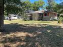 Large backyard with a screen enclosed lanai providing ideal outdoor living at 1179 Heidi Ct, Deland, FL 32720