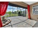 Relaxing screened patio featuring a stone fountain, brick pavers, and a view of the backyard at 1188 Eggleston Dr, Deland, FL 32724