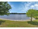 Scenic lake view showcasing a tranquil waterfront and distant houses, framed by lush trees at 1188 Eggleston Dr, Deland, FL 32724