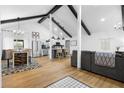 Bright open-concept living space featuring vaulted ceilings, wood floors, and modern furnishings at 1202 Anderson St, Deltona, FL 32725