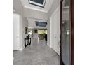Open foyer with gray tile flooring, high ceilings, and view to the living area at 1219 Victoria Hills N Dr, Deland, FL 32724