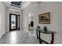 Inviting foyer with high ceilings, neutral decor, and decorative glass front door at 1219 Victoria Hills N Dr, Deland, FL 32724