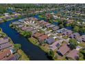 Aerial view showcasing home in a lakeside community with mature trees, green lawns, and well-maintained streets at 133 Wood Ibis Ct, Daytona Beach, FL 32119