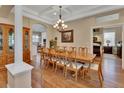 Elegant dining room features a coffered ceiling, chandelier, and wood floors at 1504 Ginger Snap, Deland, FL 32720