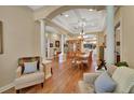 Elegant dining room with a large table, chandelier lighting, and decorative columns at 1504 Ginger Snap, Deland, FL 32720