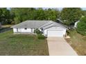 An elevated view of a cozy single-story home with a driveway and fenced yard at 1627 Alloway Dr, Deltona, FL 32738