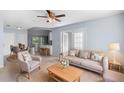 Bright living room with neutral furniture and a view of the kitchen and dining area at 1842 W Cooper Dr, Deltona, FL 32725