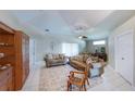 Cozy living room featuring tile floors, neutral walls, comfortable seating, and soft natural light at 1860 Turnbull Lakes Dr, New Smyrna Beach, FL 32168
