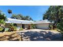 Well-maintained home with a metal roof, two-car garage, and lush landscaping enhancing its curb appeal at 1927 Orange Tree Dr, Edgewater, FL 32141