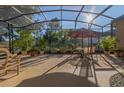 Spacious screened-in patio perfect for outdoor entertaining, featuring brick flooring and ample seating at 202 Westcott Ct, Deland, FL 32724